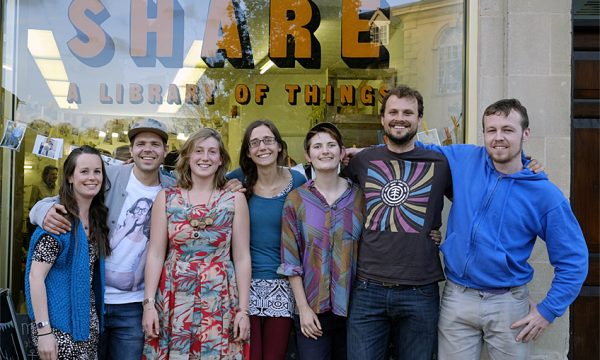 People standing in front of the Share shop window.