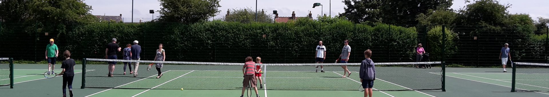 People playing tennis at Mary Baily