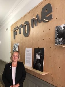 Photo of Camille Claudel in front of exhibition photographs at Frome Town Hall.