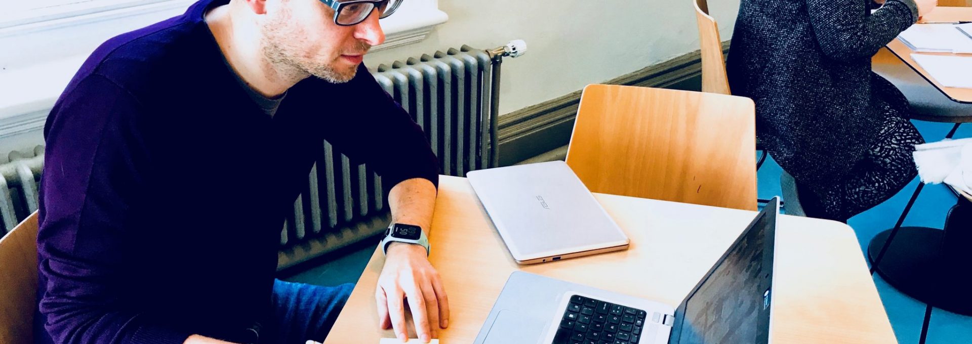 Photo of a man working at a desk.