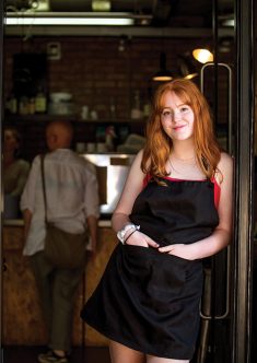 Girl standing in doorway of cafe