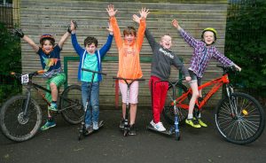 Image of young people using scooters and bikes as part of the School Travel Challenge