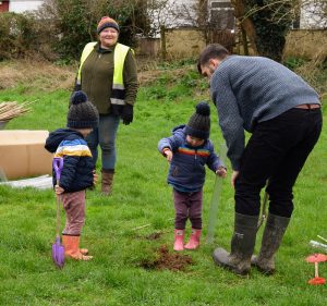 Photo of family planting trees