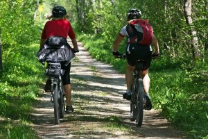 Two people riding bikes