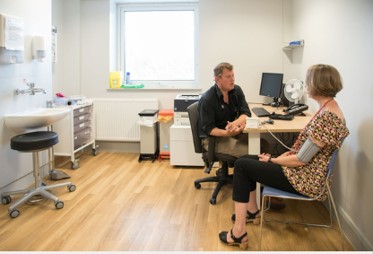 Picture of a patient with a Doctor in a consulting room