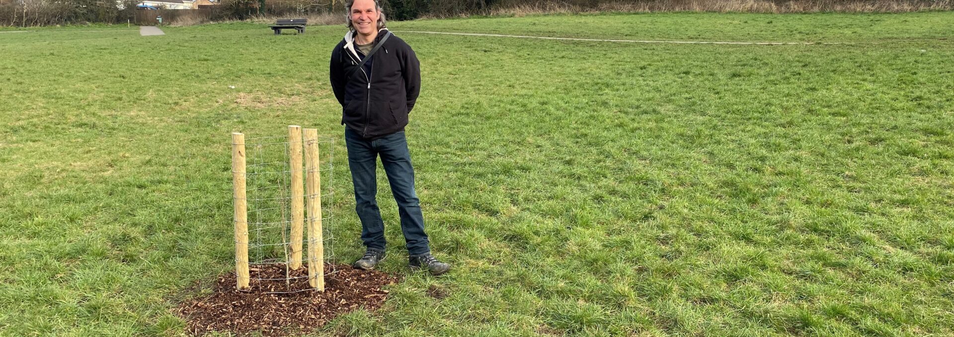 Julian High standing in Old Showfield by newly planted Oak