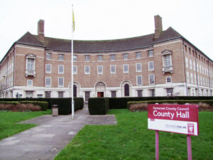 County Hall in Taunton, with a sign and lawn in  front