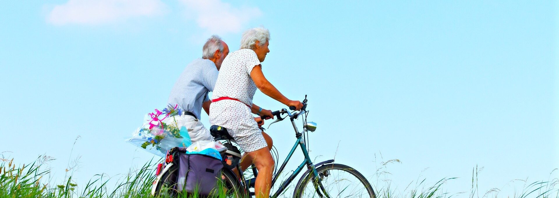 elderly couple riding bikes
