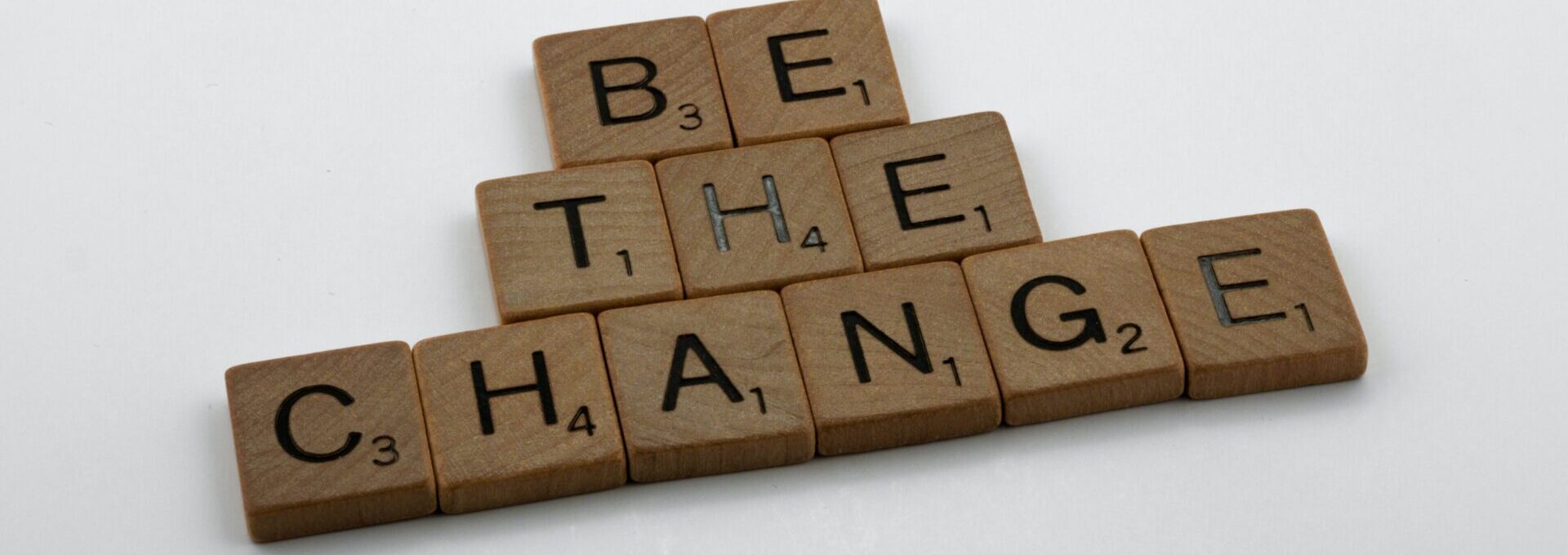 Be the change written in scrabble pieces 
