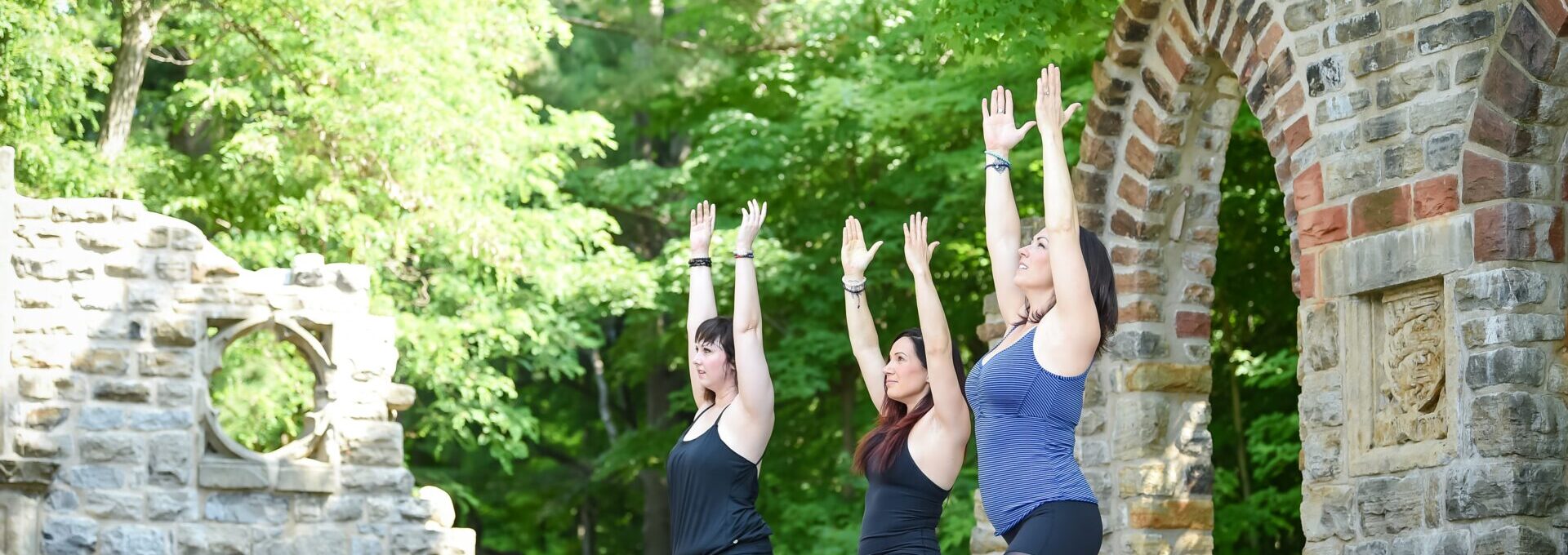 Women practising yoga outside