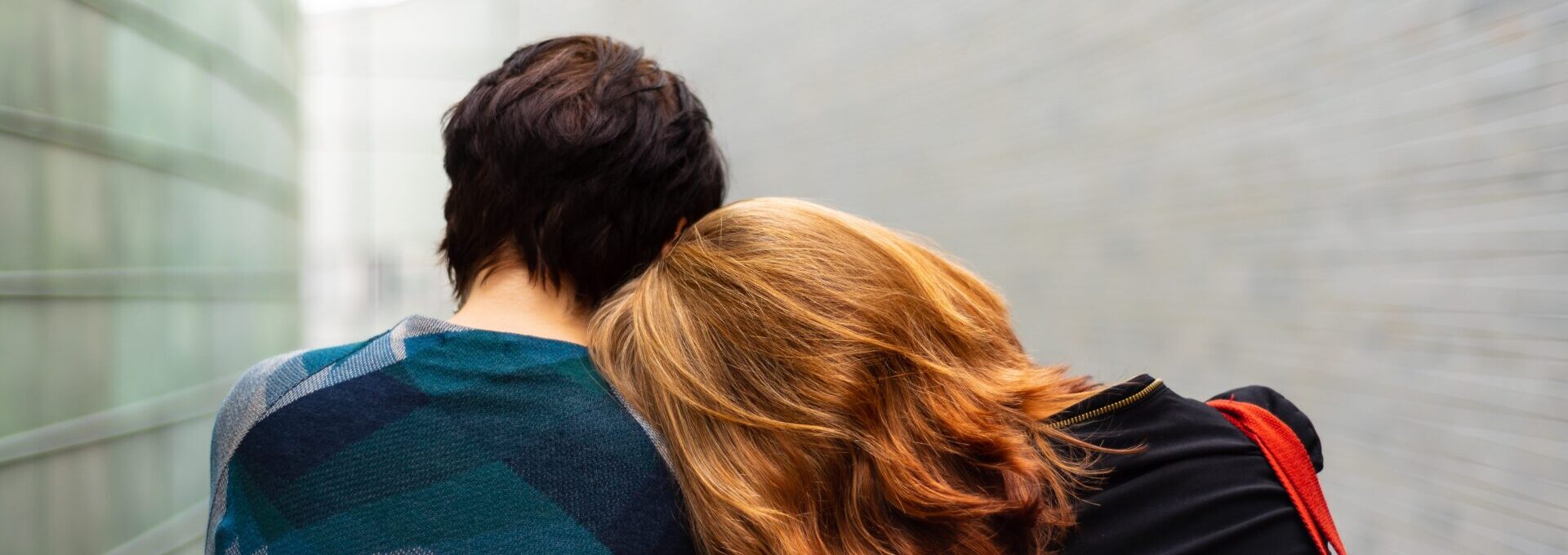 Couple with women resting head on partner's shoulder