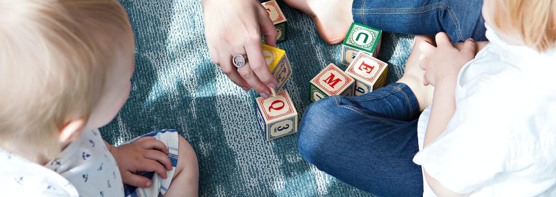 Toddlers looking at wooden blocks