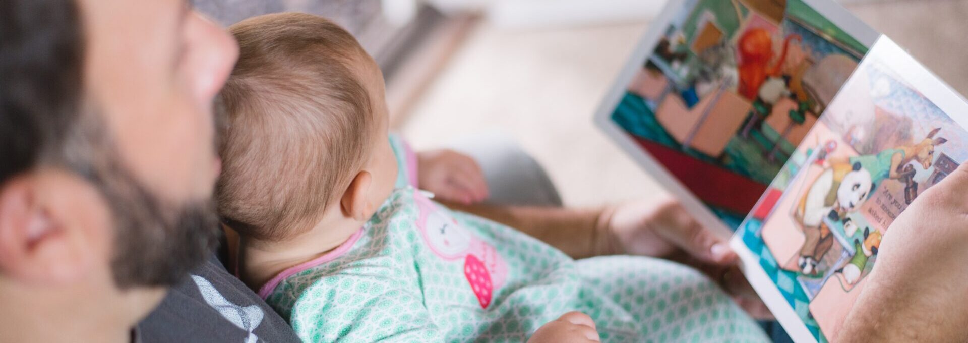 Father reading to baby