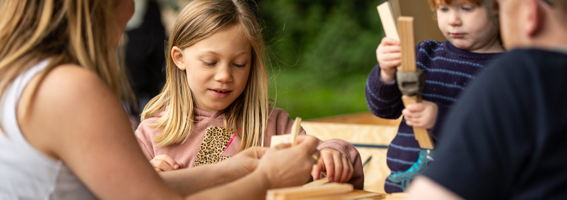 Family playing with building blocks picnic in the meadow 2021