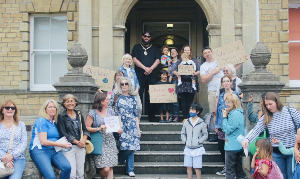  A group of peaceful demonstrators stand on Frome Town Hall steps with Mayor Andy Wrintmore