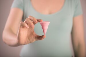 female holding menstrual cup