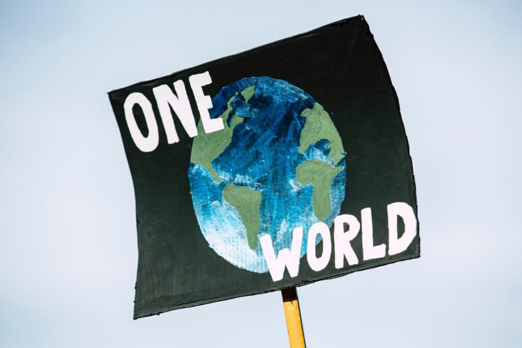 Placard with the words 'one world'