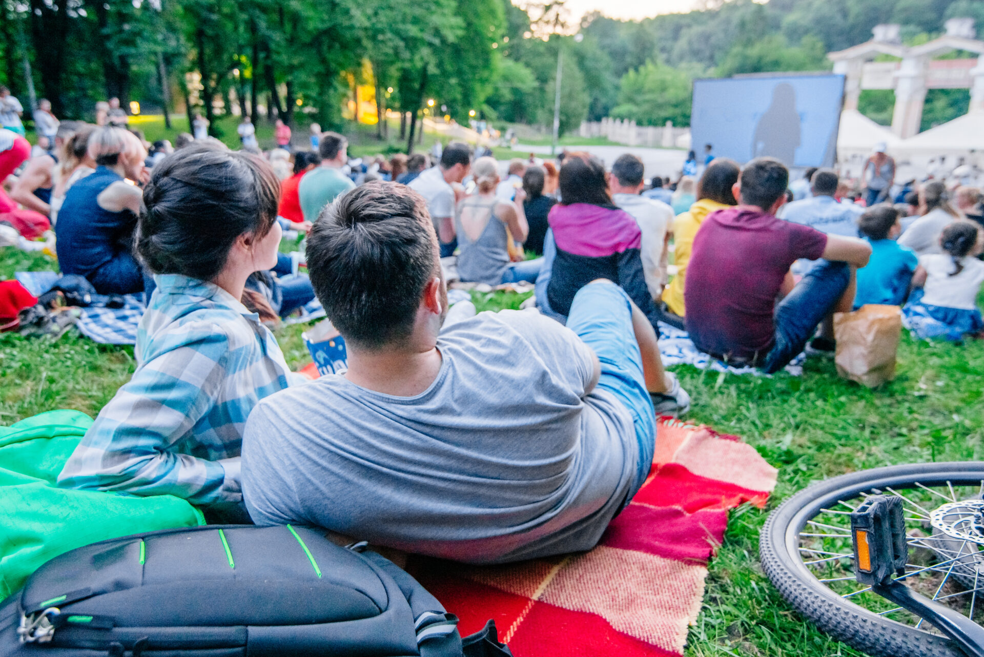 People watching a movie in open air cinema outside