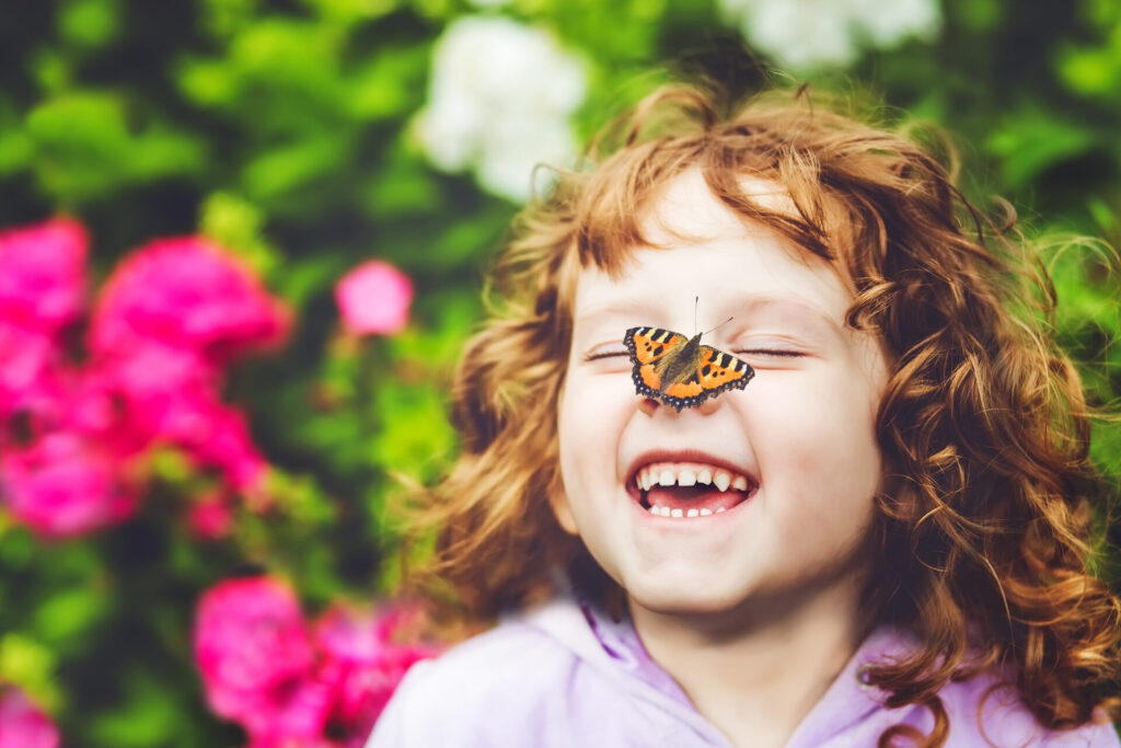 Laughing,Girl,With,A,Butterfly,On her,Nose.