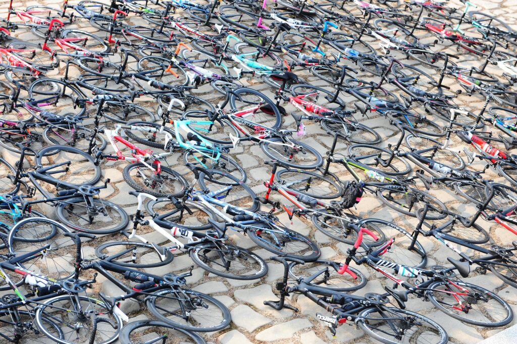Hundreds of bikes lain out on the pavement.