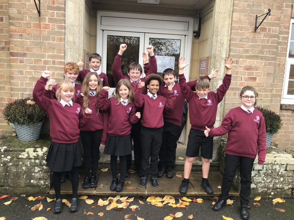 A group of schoolchildren celebrated with fists in the air