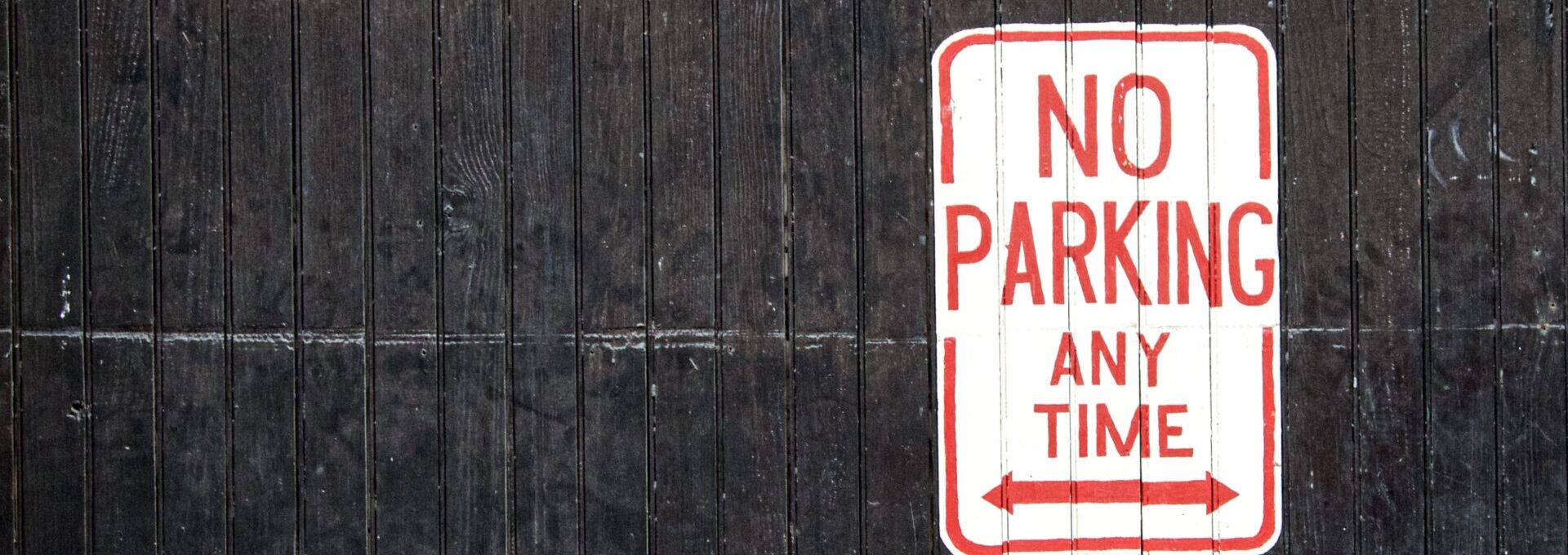 "no parking any time" sign