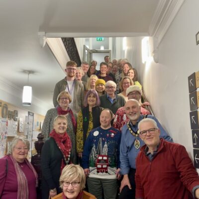Volunteers on the staircase at Frome Town Hall with Mayor Philip Campagna