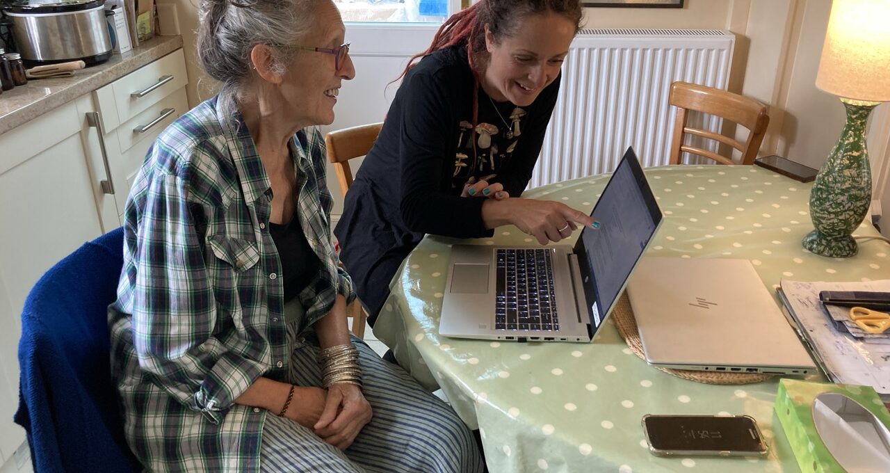 A free energy plan with local resident Bharati and Jo Morris from FTC sitting together at a kitchen table